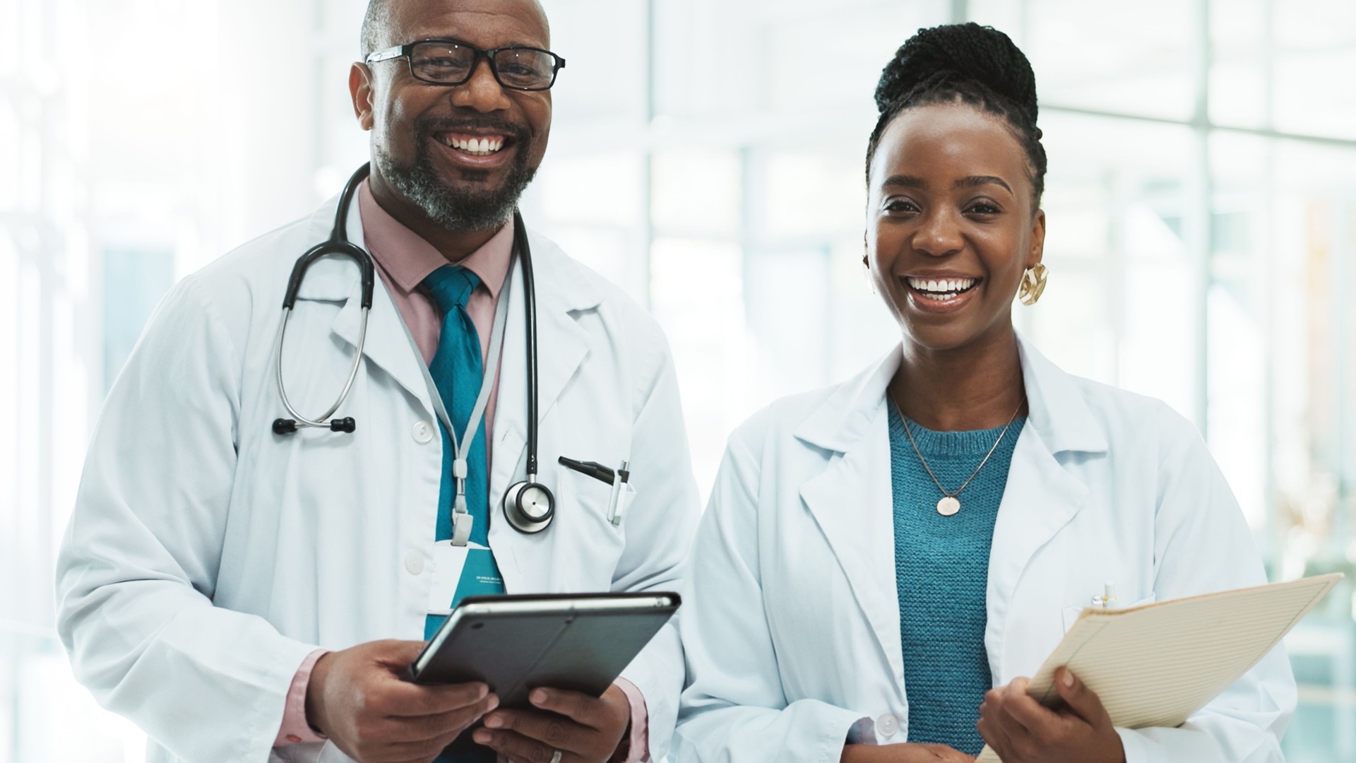 Black people, doctors and happy with folder and tablet on portrait for healthcare service. Clinic, employees and smile or proud in confidence for teamwork, collaboration and ambition